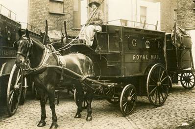 Photograph of woman driver on horsedrawn mail van from World War 1